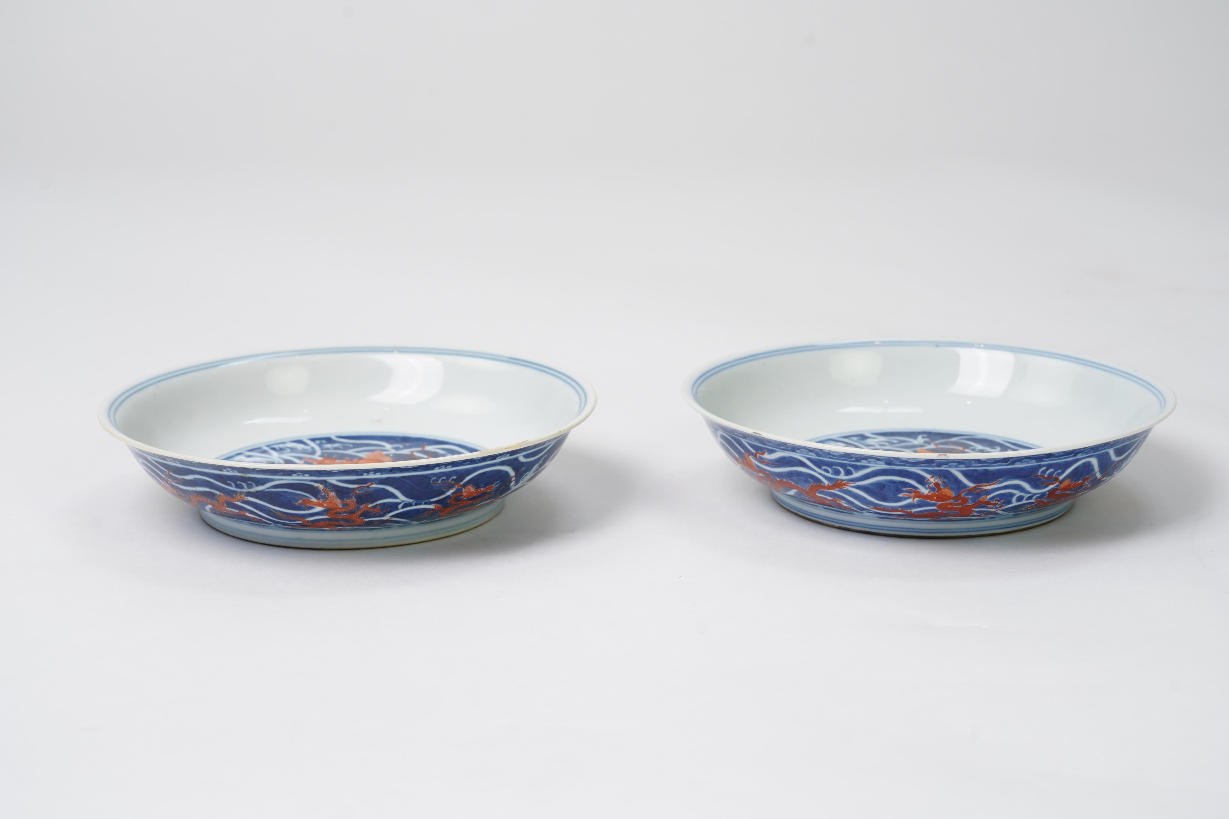 A pair of Chinese iron red and underglaze blue ‘dragon’ dishes, Qianlong seal mark and of the period (1736-95)